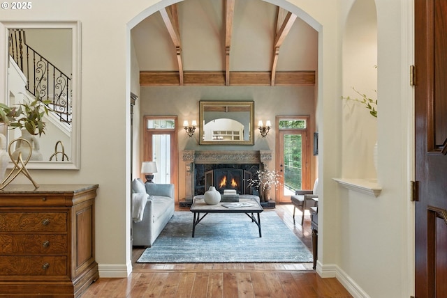 2812 Beacon Hill Dr, West Linn, OR 97068 - living area featuring wood finished floors, a high end fireplace, beam ceiling, high vaulted ceiling, and stairway