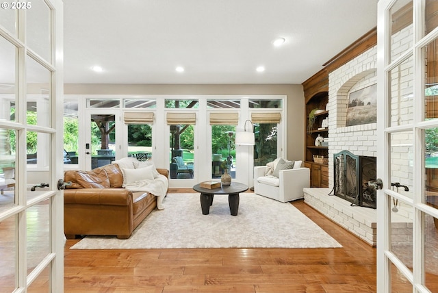 2812 Beacon Hill Dr, West Linn, OR 97068 - living area featuring french doors, wood finished floors, a fireplace, recessed lighting, and built in shelves