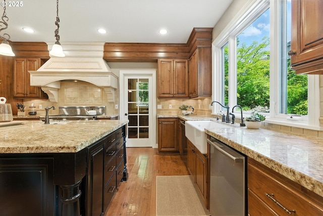 2812 Beacon Hill Dr, West Linn, OR 97068 - kitchen featuring stainless steel dishwasher, light stone counters, brown cabinetry, and recessed lighting