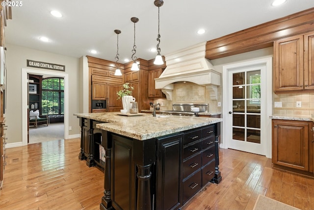 2812 Beacon Hill Dr, West Linn, OR 97068 - kitchen featuring brown cabinetry, backsplash, light wood-type flooring, and recessed lighting