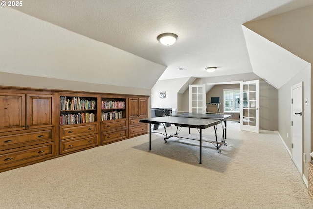 2812 Beacon Hill Dr, West Linn, OR 97068 - recreation room featuring vaulted ceiling, light carpet, a textured ceiling, and french doors