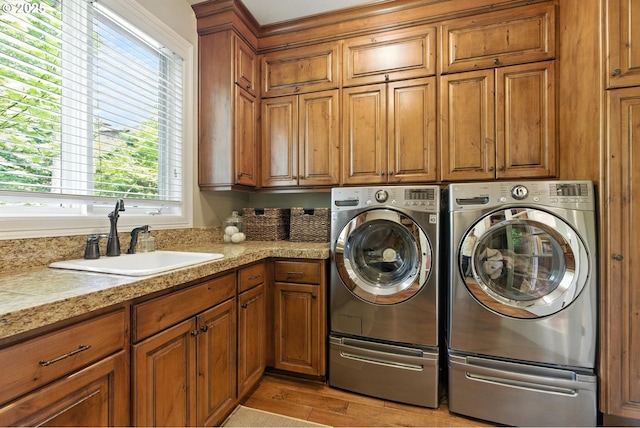 2812 Beacon Hill Dr, West Linn, OR 97068 - laundry room featuring cabinet space, separate washer and dryer, and light wood-style floors