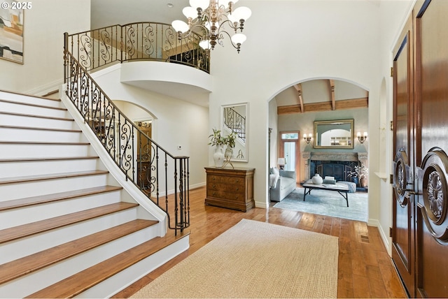 2812 Beacon Hill Dr, West Linn, OR 97068 - foyer entrance featuring arched walkways, a towering ceiling, hardwood / wood-style floors, a fireplace, and stairway