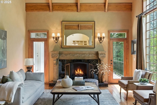 2812 Beacon Hill Dr, West Linn, OR 97068 - living area with wood finished floors, beam ceiling, coffered ceiling, a fireplace, and healthy amount of natural light
