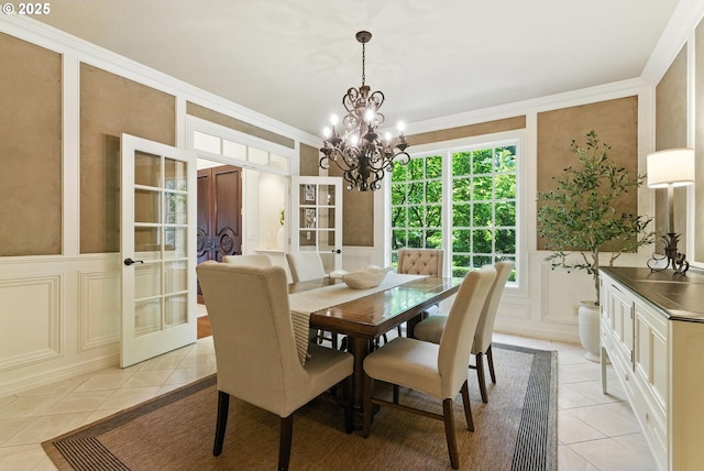 2812 Beacon Hill Dr, West Linn, OR 97068 - dining area featuring a decorative wall, light tile patterned floors, french doors, a chandelier, and ornamental molding
