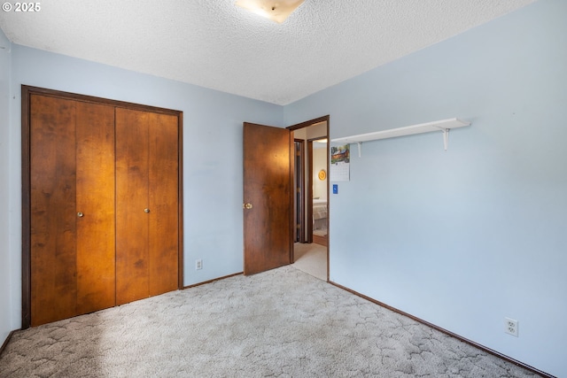 44505 SW Knight Rd, Gaston, OR 97119 - unfurnished bedroom with a closet, carpet floors, a textured ceiling, and baseboards