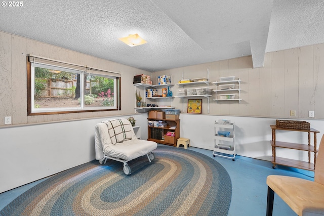 44505 SW Knight Rd, Gaston, OR 97119 - living area featuring a textured ceiling, wood walls, and concrete flooring