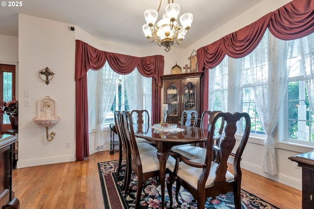 34085 Berg Rd, Warren, OR 97053 - dining space featuring a chandelier, baseboards, and light wood-style floors