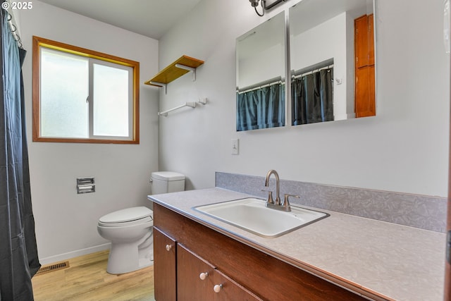 4803 SE Fieldcrest Dr, Milwaukie, OR 97222 - bathroom with vanity, wood finished floors, toilet, baseboards, and curtained shower