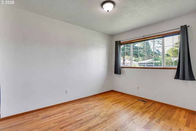 4803 SE Fieldcrest Dr, Milwaukie, OR 97222 - unfurnished room featuring a textured ceiling, wood finished floors, and baseboards