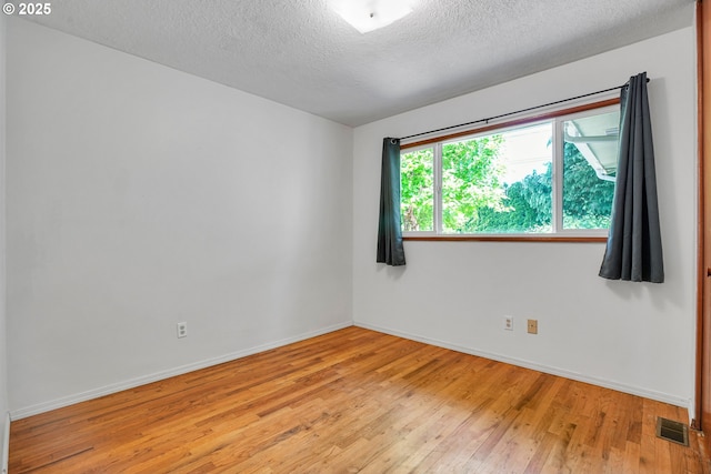 4803 SE Fieldcrest Dr, Milwaukie, OR 97222 - spare room with light wood-style floors, a textured ceiling, and baseboards