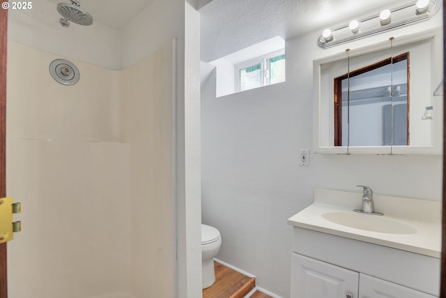 4803 SE Fieldcrest Dr, Milwaukie, OR 97222 - bathroom featuring vanity, a shower, toilet, and wood finished floors