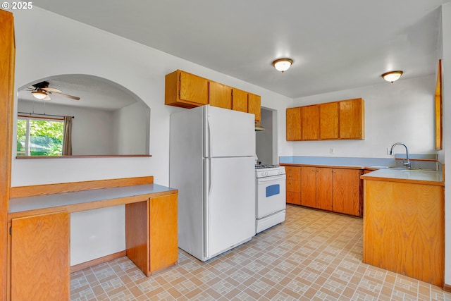 4803 SE Fieldcrest Dr, Milwaukie, OR 97222 - kitchen featuring white appliances, a sink, brown cabinets, a ceiling fan, and light countertops