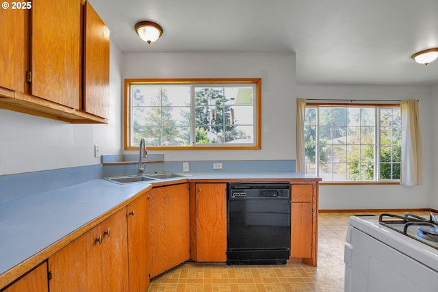4803 SE Fieldcrest Dr, Milwaukie, OR 97222 - kitchen with black dishwasher, a sink, white range with gas stovetop, light countertops, and brown cabinets