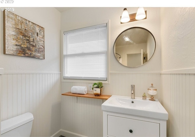 2747 NE Bryant St, Portland, OR 97211 - bathroom featuring wainscoting, vanity, and toilet