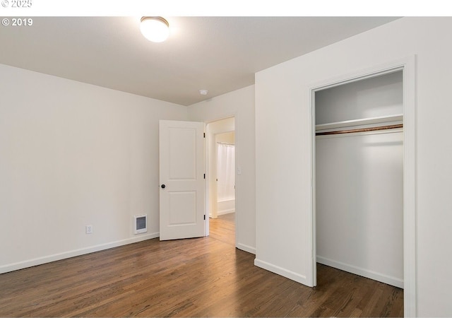 2747 NE Bryant St, Portland, OR 97211 - unfurnished bedroom with wood finished floors, a closet, and baseboards