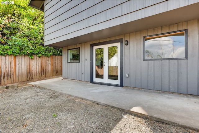 2747 NE Bryant St, Portland, OR 97211 - doorway to property with a patio area, french doors, and board and batten siding
