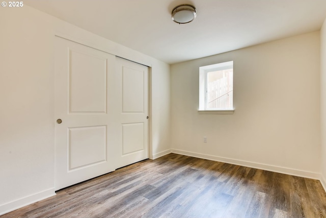 2747 NE Bryant St, Portland, OR 97211 - unfurnished bedroom featuring wood finished floors, baseboards, and a closet