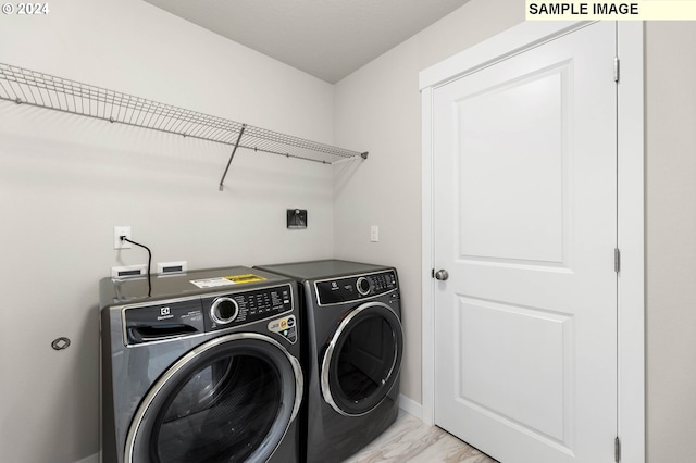 4205 NE 186th St Lot 265, Vancouver, WA 98686 - clothes washing area with washing machine and clothes dryer, light marble finish floors, and baseboards