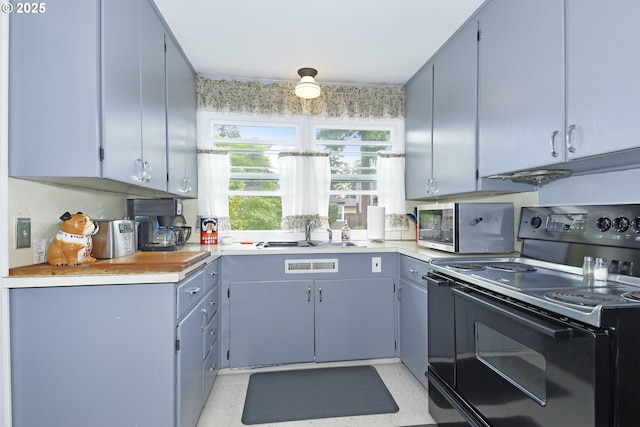 6325 SE 77th Ave SE, Portland, OR 97206 - kitchen with electric range, stainless steel microwave, and light countertops