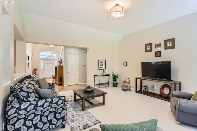 living room with baseboards and vaulted ceiling