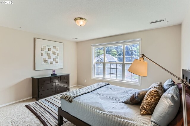 bedroom featuring baseboards, carpet, and visible vents