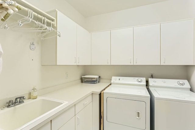 laundry area featuring a sink, cabinet space, and washer and clothes dryer