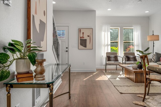 4409 NE Killingsworth St Unit 103, Portland, OR 97218 - living room with wood finished floors, stairway, and recessed lighting