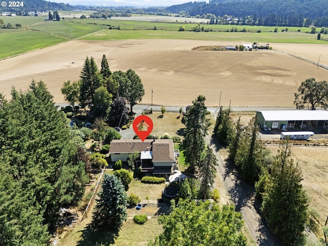 birds eye view of property with a rural view