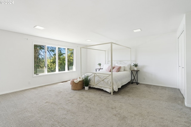 carpeted bedroom featuring visible vents and baseboards