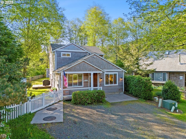 bungalow-style home featuring fence and covered porch