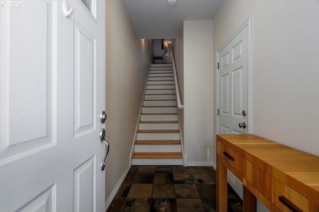 staircase with baseboards and stone finish flooring