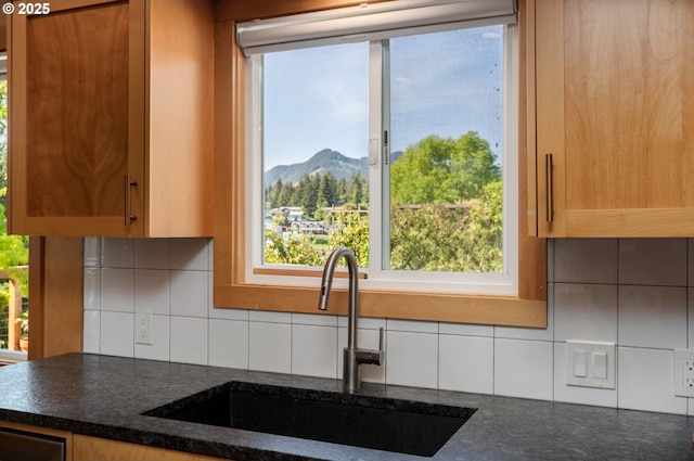 12990 I St, Nehalem, OR 97131 - kitchen with a sink, a mountain view, backsplash, and dark stone counters