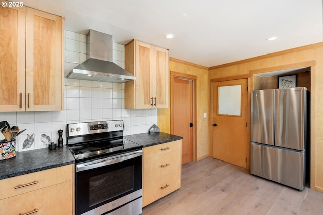 12990 I St, Nehalem, OR 97131 - kitchen featuring stainless steel appliances, wall chimney range hood, light brown cabinetry, dark countertops, and recessed lighting