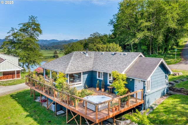 12990 I St, Nehalem, OR 97131 - back of property featuring roof with shingles, a deck with mountain view, and a lawn