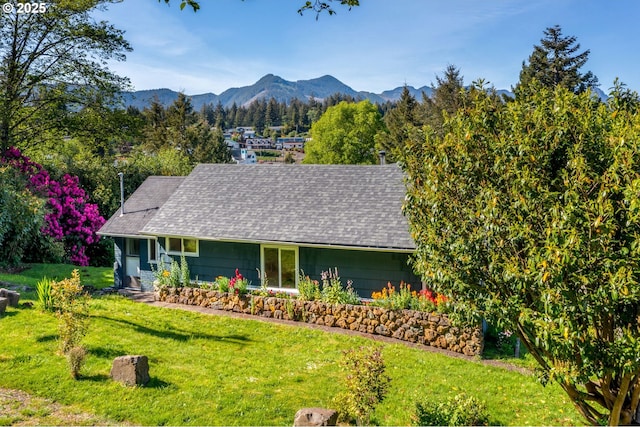 12990 I St, Nehalem, OR 97131 - ranch-style house featuring a front yard, a mountain view, and a shingled roof