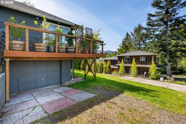 12990 I St, Nehalem, OR 97131 - view of front of house featuring a front lawn, an attached garage, and driveway