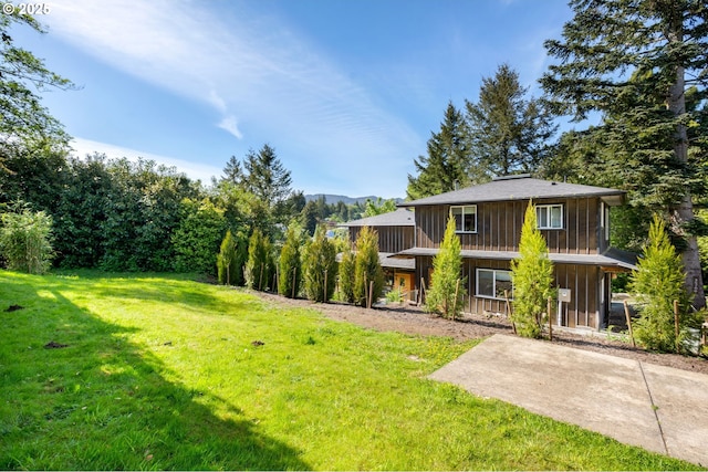 12990 I St, Nehalem, OR 97131 - view of grassy yard featuring a mountain view and a patio area