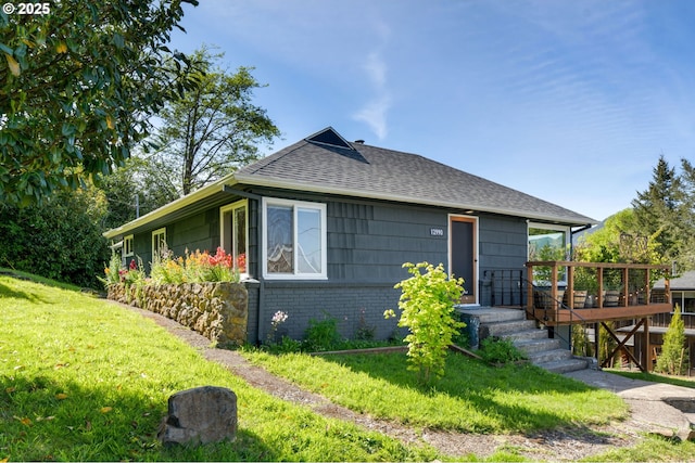 12990 I St, Nehalem, OR 97131 - view of front of house featuring a front yard, roof with shingles, and brick siding