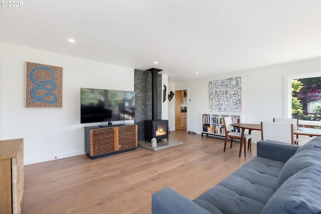 12990 I St, Nehalem, OR 97131 - living area with a wood stove, wood finished floors, recessed lighting, and baseboards