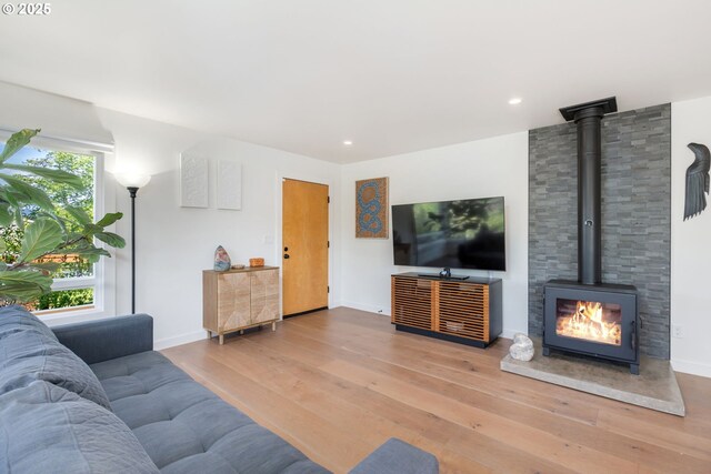 12990 I St, Nehalem, OR 97131 - living room featuring a wood stove, hardwood / wood-style floors, baseboards, and recessed lighting