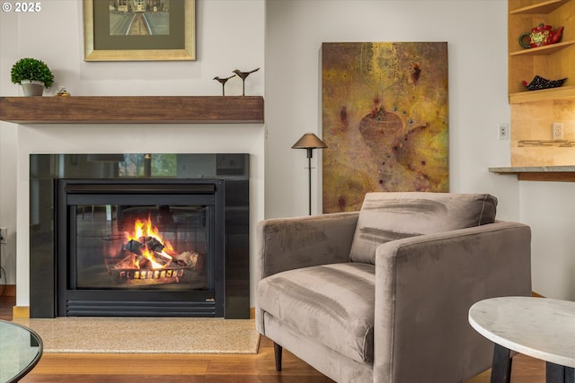 1030 NW Johnson St Unit 323, Portland, OR 97209 - sitting room with wood finished floors and a glass covered fireplace