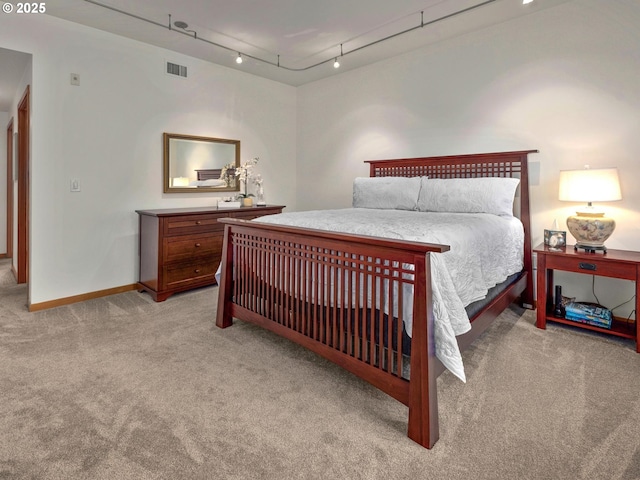 1030 NW Johnson St Unit 323, Portland, OR 97209 - bedroom with light carpet, baseboards, and track lighting