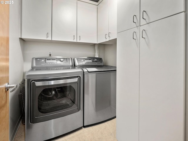 1030 NW Johnson St Unit 323, Portland, OR 97209 - laundry area with washer and clothes dryer and cabinet space
