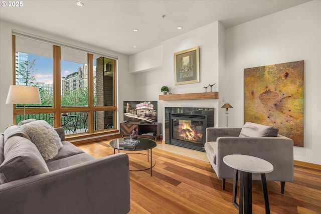 1030 NW Johnson St Unit 323, Portland, OR 97209 - living area with wood finished floors, recessed lighting, and a glass covered fireplace