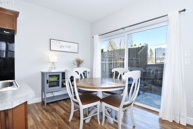 dining area with dark hardwood / wood-style flooring