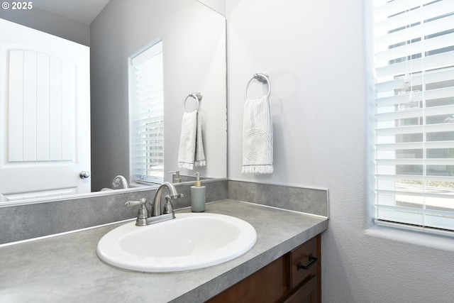 bathroom with plenty of natural light and vanity