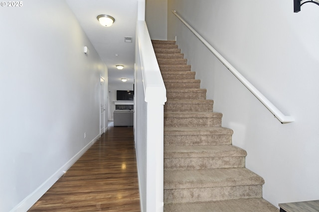 stairway with hardwood / wood-style flooring