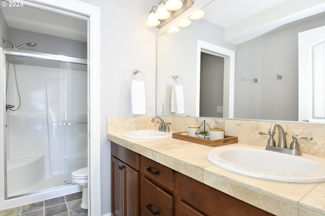 bathroom with toilet, vanity, and walk in shower