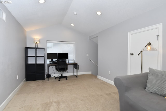 carpeted office space with vaulted ceiling